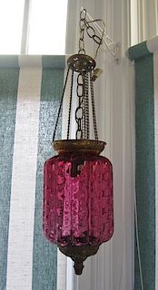 A Cranberry Hobnail Glass Hanging Lantern, Height 22 x diameter 7 1/2 inches.