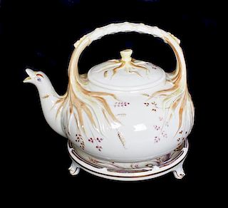 A Belleek Grass Teapot and Stand, Height on stand 6 3/4 inches.