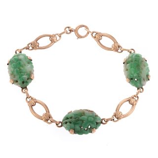 A Ladies Carved Jade Bracelet in Gold