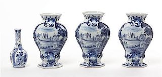 A Set of Three Delft Ceramic Vases, Height of first three 7 3/4 inches.