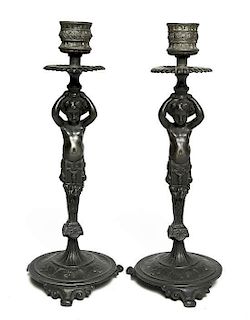 A Pair of Continental Bronze Figural Candlesticks, Height 7 inches.