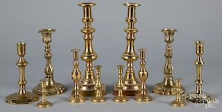 Six pairs of brass candlesticks