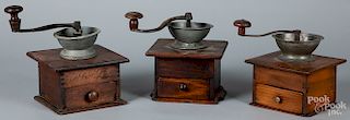 Three coffee grinders, with pewter bowls