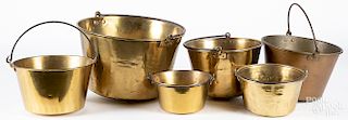 Six brass buckets