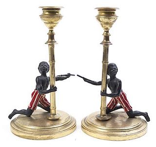 A Pair of Brass Mounted Blackamoor Candlesticks, Height 7 1/4 inches.
