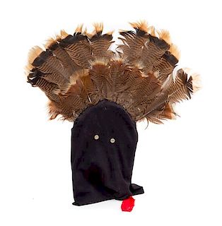 An Apache Ga'an Dance Mask with Applied Feathers Height 28 x width 27 inches.