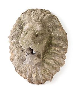 A Pair of Carved Stone Lion Masks Height 19 inches.