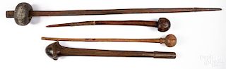Four ethnographic wooden clubs.