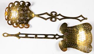 Two elaborate brass straining ladles, 20th c.