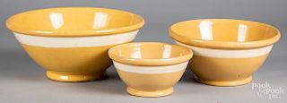 Three yelloware mixing bowls