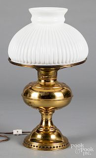 Brass fluid lamp, with a milk glass shade.