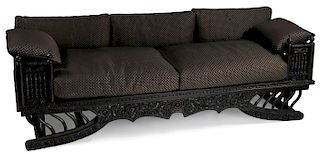 A LARGE CARVED WOOD HOWDAH STYLE THAI SOFA