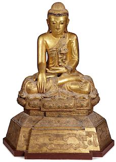 A LARGE AND IMPOSING CARVED GILT WOOD BUDDHA
