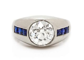 An 18 Karat White Gold, Diamond and Synthetic Sapphire Ring, 5.85 dwts.