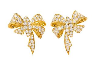 * A Pair of Yellow Gold and Diamond Bow Motif Earclips, 11.00 dwts.