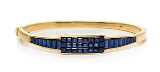 A Yellow Gold and Sapphire Bangle Bracelet, Kurt Wayne, 22.30 dwts.