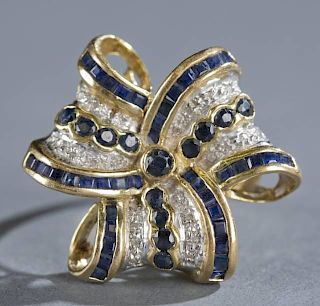 Three ribbon bow ring with diamonds and sapphires.