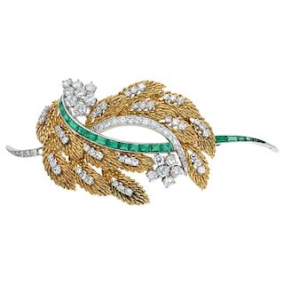 An emerald and diamond 14K yellow and white gold brooch.