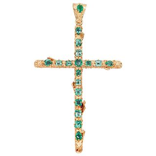 An emerald 14K yellow gold cross pendant.