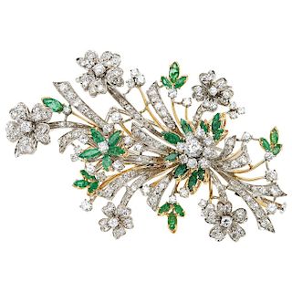 An emerald and diamond 18K white and yellow gold brooch.