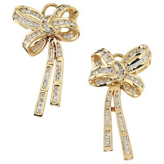 A pair of diamond 14K yellow gold earrings.