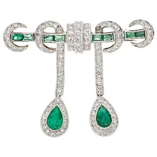 An emerald and diamond palladium silver brooch.
