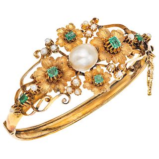 A cultured pearl and emerald 10K yellow gold bangle.