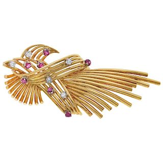 A ruby and diamond 18K yellow gold pendant/brooch.
