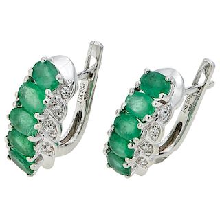 A pair of emerald and diamond 14K white gold earrings.