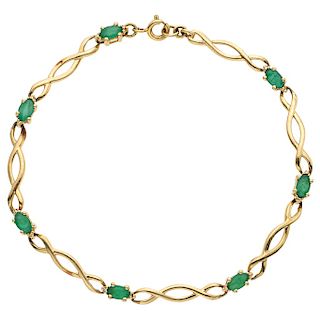An emerald 14K yellow gold bracelet.