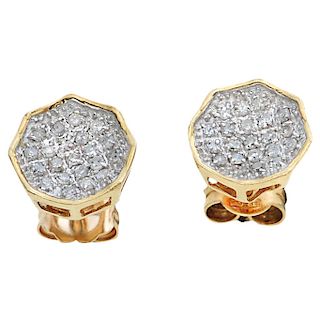 A pair of diamond 14K and 10K yellow gold stud earrings.