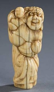 A Japanese ivory netsuke of a man with child.