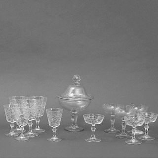 Bombonera y 22 copas. Siglo XX. Elaboradas en cristal cortado. Decorado esmerilado con roleos y elementos fitomorfos.