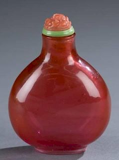 A Chinese pink rounded glass snuff bottle.