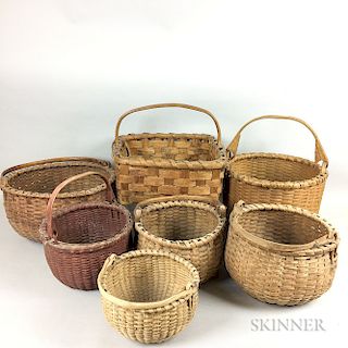 Seven Woven Splint Swing-handled Baskets.  Estimate $100-200