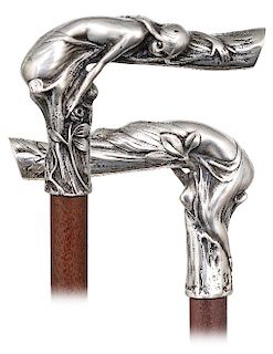 28. Silver Art Nouveau Cane -Ca. 1900 -L-shaped silver handle modeled to depict a beautiful young girl gracefully leaning over a tree branch to pick a