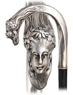 35. Silver Figural Art Nouveau Cane -Ca. 1900 -Well-proportioned crook silver handle embellished with a female head festooned with flowers at the fron