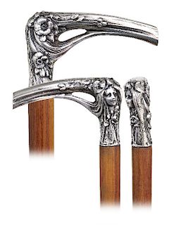 48. Silver Figural Art Nouveau Cane -Ca. 1900  -L-shaped silver handle, well-modeled, heavy cast and finely hand chased to depict a female head in Sym