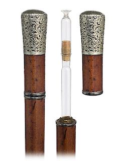 49. Tippler Cane -Ca. 1900 -Large and well chased white metal knob on a malacca shaft with a metal ferrule. The cane breaks in two parts through a thr