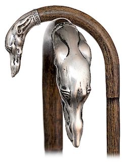 55. Silver Dog Head Cane -Ca. 1900 -Slender and stepped partridge cane with an integral crook handle embellished with a silver whippet head cap and a 