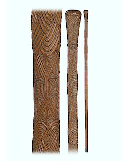 63. Polynesian Maori Cane -Ca. 1890 -Fashioned of a hardwood branch freed from its bark with a natural bough as knob and entirely carved with various 