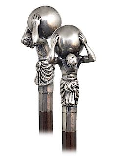 100. Silver Figural Cane -20st Century -Large and stretching silver handle with a Hercules holding a globe on his shoulder, plain silver collar, eboni