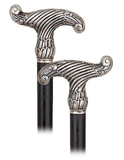168. Silver Dress Cane -Ca. 1890 -Derby shaped silver handle hand chased and engraved in the Baroque taste, ebony shaft and a horn ferrule. Way out of