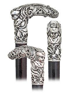 172. Silver figural Day Dane -Ca. 1890 -L-shaped silver handle modeled with pleasing rounded edges in a rich Baroque taste with dense scrolls, shells 