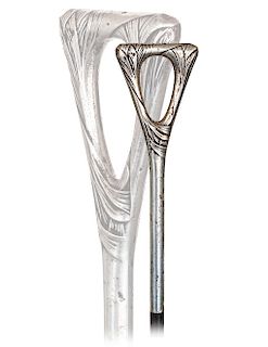 177. Silver Art Nouveau Dress Cane -Ca. 1910 -Vertical silver handle with a gracious triangular loop top modeled with wrapping foliage ornamentation o