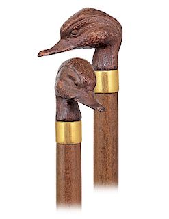 195. Duck Head Day Cane -Ca. 1920 -Bronze knob cast in the shape of a duck head, plain and gilt metal collar, fruitwood shaft and a metal ferrule. Del