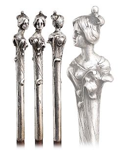74. Silver Figural Art Nouveau Cane -Ca. 1900  -Straight silver handle well modeled with the bust of a beauty emerging out of leafage. Her upswept hai
