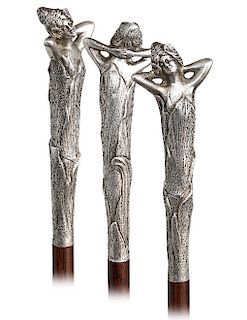 76. Silver Figural Art Nouveau Cane -Ca. 1900  -Delicately modeled with the bust of a beauty with upswept hair tucked with flowers and arms folded beh