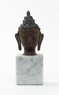 A Southeast Asian Bronze Head of Buddha, Height of bronze 4 3/4 inches.