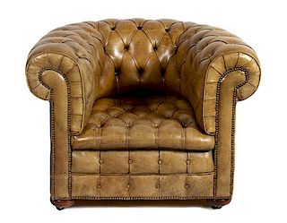 A Leather-Upholstered Chesterfield Armchair Height 31 x width 39 x depth 37 inches.